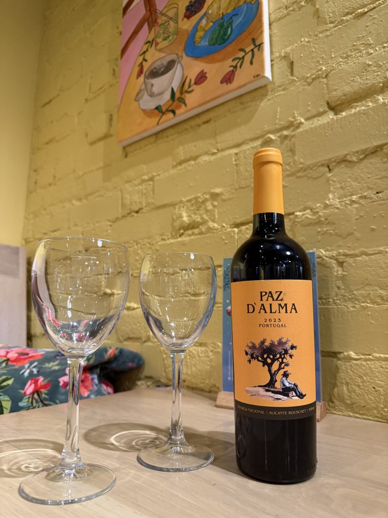 Photo of two wine glasses with bottle of Paz D'Alma Syrah wine